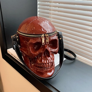 Glossy brown skull crossbody bag with gold zippers in a punk art style for Halloween