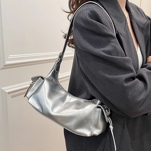 Silver metallic dumpling shoulder bag with bow detail and adjustable strap for women