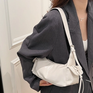 White hobo shoulder bag in shiny patent leather with side lace-up bow and adjustable strap