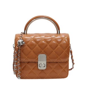 Sac à bandoulière marron matelassé avec poignée en argent et bandoulière chaîne sur fond blanc
