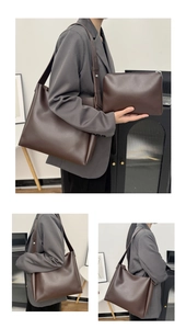 Detail of dark brown tote bag set with side metal rivets and matching zipper pouch