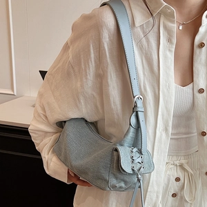 Light blue denim bow shoulder bag with lace-up side detail and adjustable strap