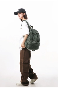 Detail view of large capacity dark green corduroy backpack with sturdy shoulder straps