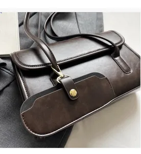 Detailed macro of vintage brown shoulder bag with a small detachable coin purse accessory