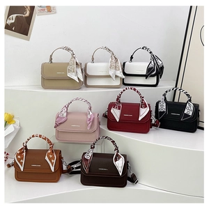 Collection of multi-layered crossbody bags in eight colors with elegant silk scarf handles