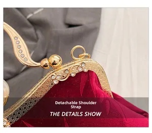 Detail of burgundy velvet evening bag with gold metal frame and sparkling rhinestones