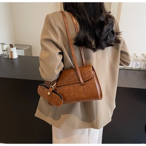 Brown vintage underarm bag detail featuring a detachable small pouch and matte PU leather