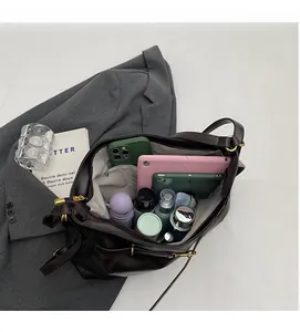 Interior view of large capacity dark brown faux leather tote bag with various compartments