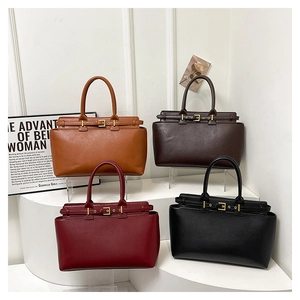Detail view of large faux leather tote bags in tan, dark brown, burgundy, and black