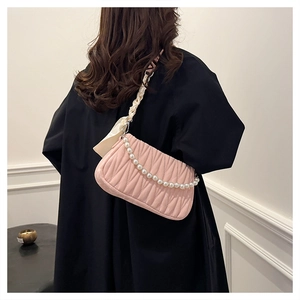 Pink shoulder bag featuring pleated texture and elegant faux pearl chain detail