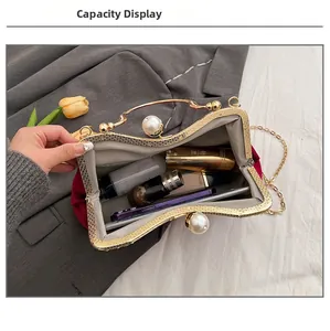 Detail showing red velvet clutch bag capacity with phone and cosmetics inside