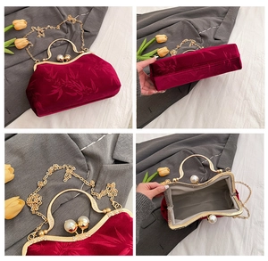 Detail of burgundy velvet handbag with bamboo pattern, gold pearl clasp and chain