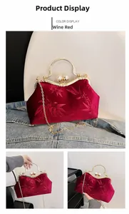 Detail of wine red velvet handbag with bamboo leaf prints and pearl clasp closure