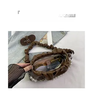 Brown pleated cloud handbag detail with pearl handle and inner storage for cosmetics