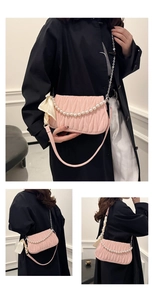 Detail view of pink quilted shoulder bag featuring pearl chain and elegant silk scarf accent