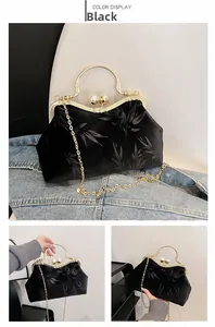 Detail of vintage black velvet handbag with embossed bamboo leaves and pearl clasp