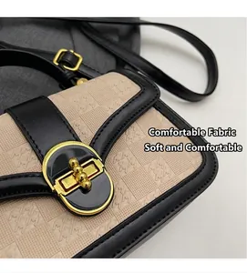 Detail of the chic beige houndstooth texture and golden twist lock on the mini bag
