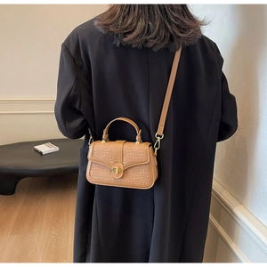Detailed back view of a brown embossed checkerboard small square bag with metal lock