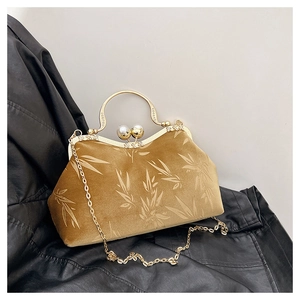 Detail of vintage velvet kiss-lock bag with bamboo leaf pattern and pearl clasp handle