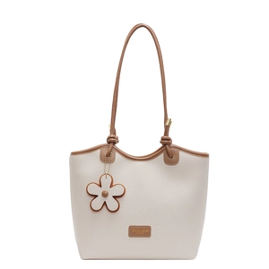 Beige lychee leather bucket tote bag with brown trim and floral charm for women