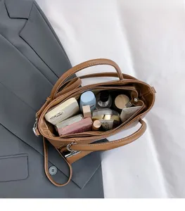 Macro view of large capacity brown pebbled leather interior with organized compartments