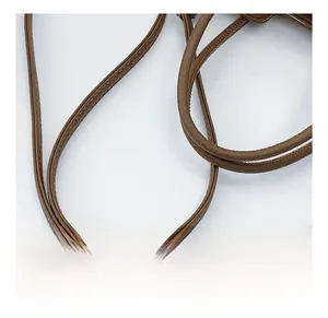 Detail of brown leather bucket bag showing comfortable shoulder straps and fine stitching