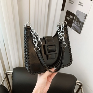 Modern black contrast bucket bag with U-shaped design and silver metal chain strap