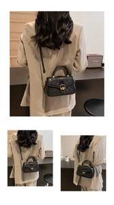 Detail of black checkered crossbody bag with gold twist lock and adjustable strap
