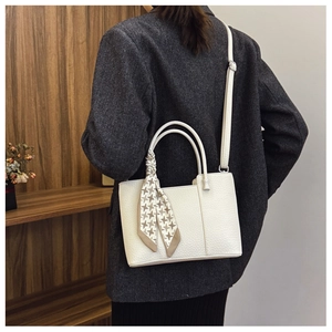 Detailed view of a white pebble grain tote bag with decorative houndstooth silk scarf