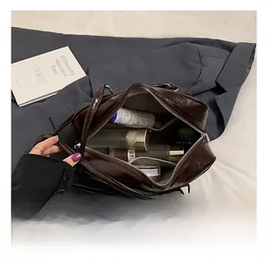 Detail view of large capacity vintage brown bag showing organized inner compartments
