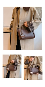 Detail of brown litchi leather handbag with decorative mini pouch and shoulder strap