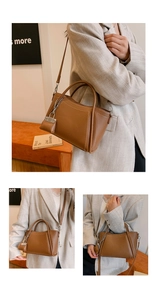 Close-up of brown litchi grain leather bag showing contrast stitching and silver lock charm
