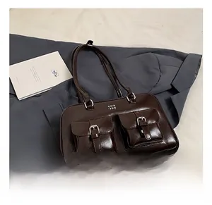 Detail view of coffee brown vintage tote bag with dual front pockets and silver buckles