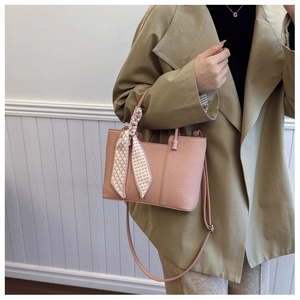 Pink tote bag detail with lychee leather texture and heart print silk scarf handle decoration