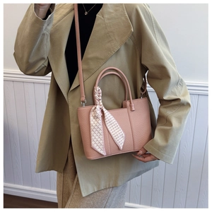 Pink lychee texture tote bag with silk scarf detail styled with a khaki trench coat