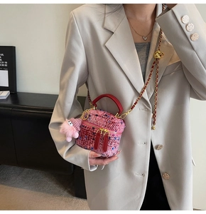 Pink tweed crossbody bag detail featuring red leather handles and cute plush charm