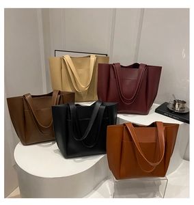Detailed display of large capacity tote bags in five matte leather colors with long straps