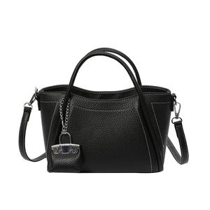 Minimalist black PU leather tote bag with white contrast stitching and dual top handles