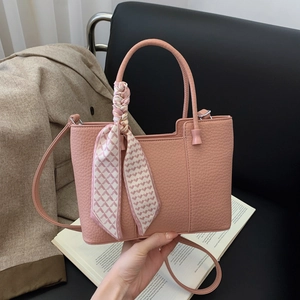 Pink lychee texture handbag with decorative scarf and shoulder strap for daily commuting