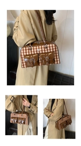 Detail of vintage wool plaid bag with brown leather trim and metallic buckle pockets