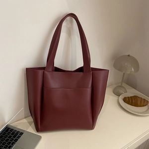 Minimalist burgundy faux leather tote bag with lychee texture and large front pocket