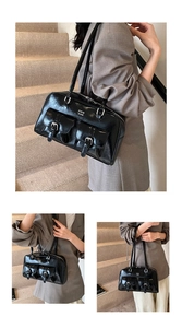 Detail view of glossy black faux leather shoulder bag with two buckled front pockets
