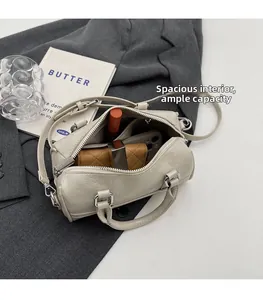 Detail view of cream bowling bag interior showing large capacity for phone and wallet