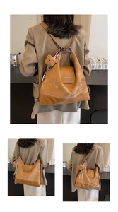 Close-up of caramel retro leather backpack with teddy bear charm and striped scarf detail