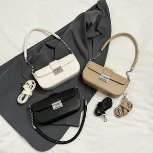 Detailed flat lay of rectangular flap bags in white, khaki, and black with silver hardware