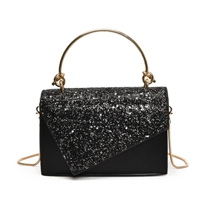 Elegant black sequin evening bag with gold ring handle and metallic chain strap