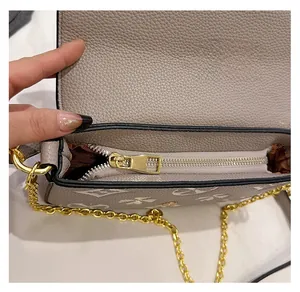 Detail view of the smooth metal zipper and internal compartment on the printed handbag