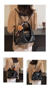 Detail of black oil wax leather tote showing versatile backpack and shoulder straps