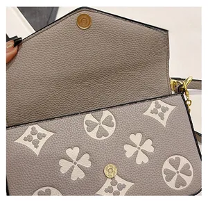 Close-up of magnetic snap closure on a floral pattern faux leather flap handbag