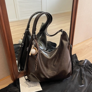 Vintage dark brown leather hobo tote bag with stylish baseball pendant accessories